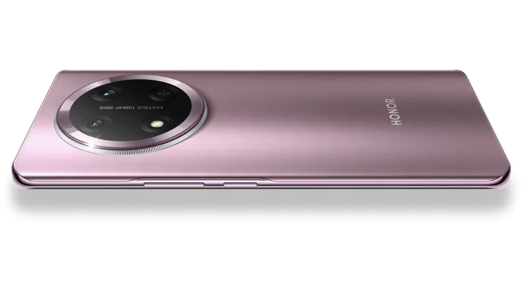 Pink Honor smartphone lying flat, showcasing the camera and elegant design.